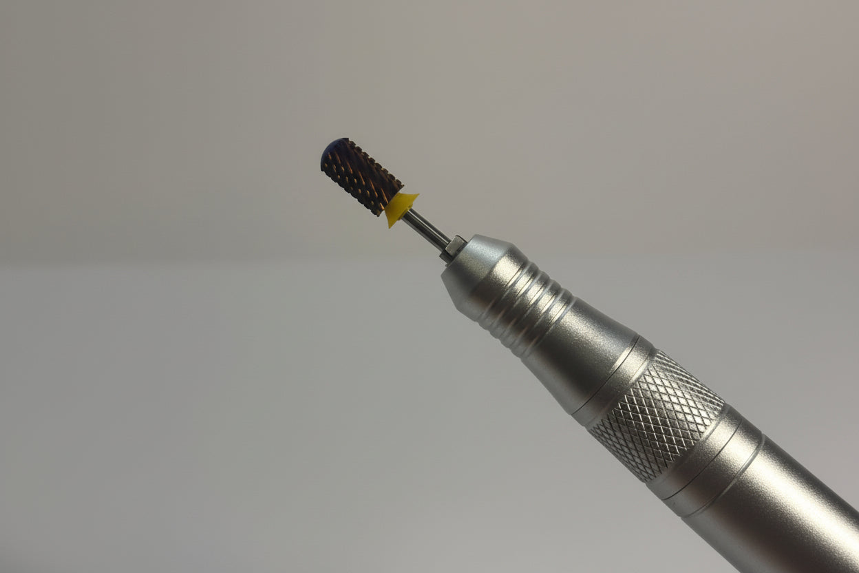 Metal tool with a small black and yellow object on a gray background