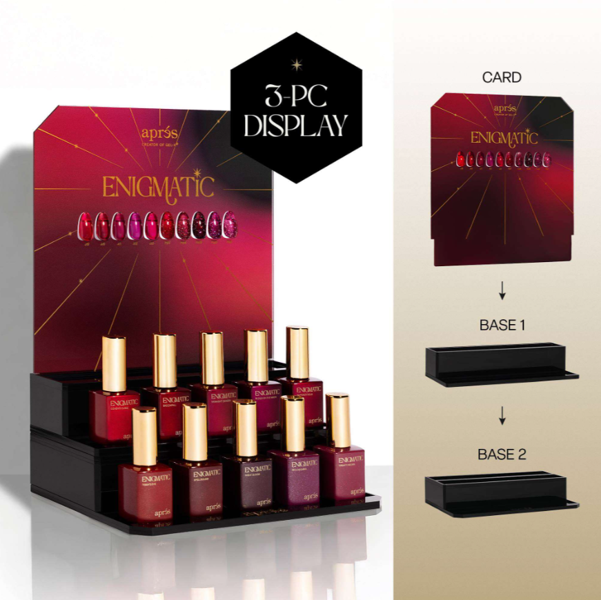 Après Enigmatic nail polish display set showing a 3-pack display stand with six bottles of nail polish, alongside a card and black display bases on a beige background.