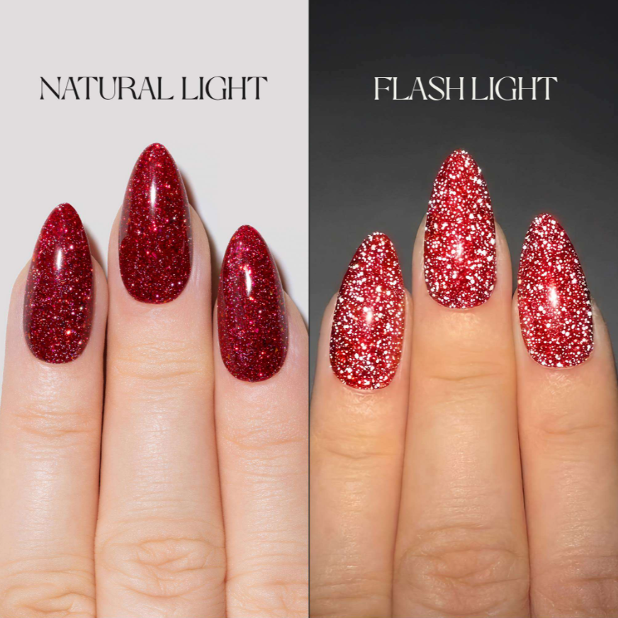 A split-screen comparison showing red glitter nail polish applied to fingernails under two lighting conditions: 'NATURAL LIGHT' on the left and 'FLASH LIGHT' on the right. The nails are shown on a hand against a light gray background on the left and a dark gray background on the right.