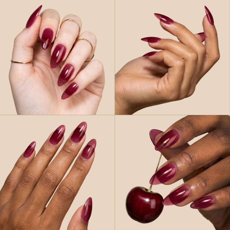 Four-panel collage showing manicured hands with long, almond-shaped nails painted in a deep burgundy shade, including one hand holding a red cherry. The background is a solid warm beige.