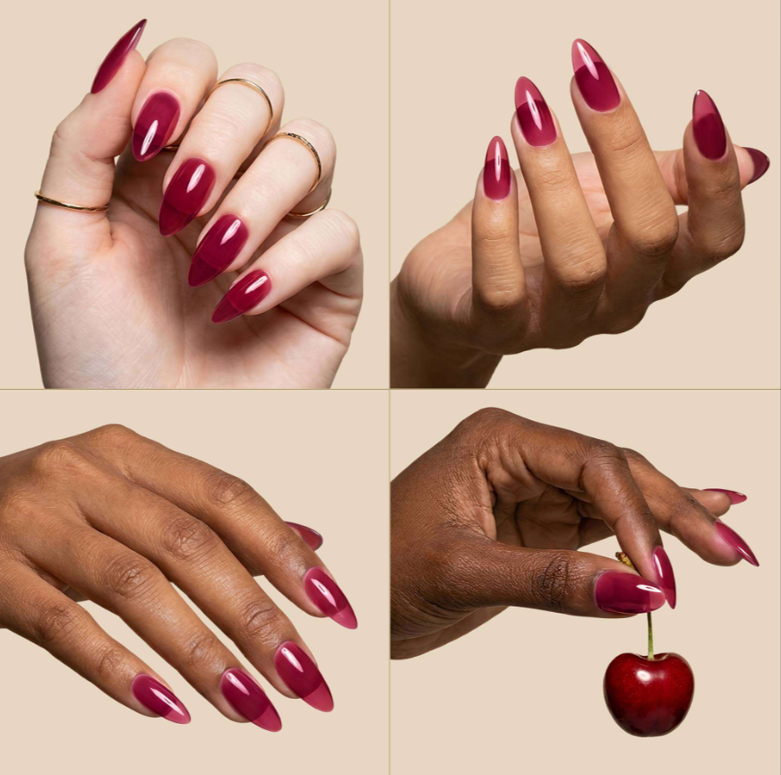 Four-panel collage showing manicured hands with long almond-shaped nails painted in a glossy deep berry pink shade, with one hand holding a red cherry. The background is a warm light beige.