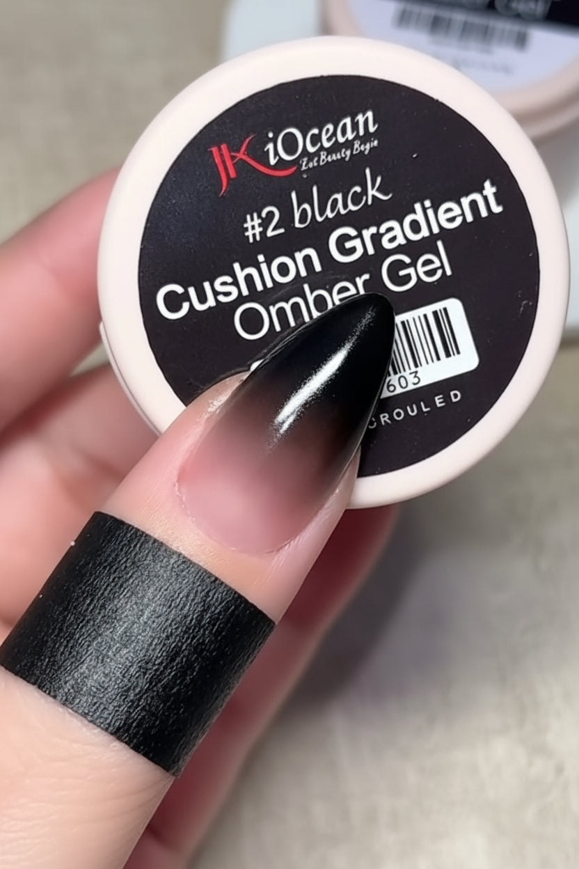 Hand holding a container of JK IOcean #2 black Cushion Gradient Omber Gel.