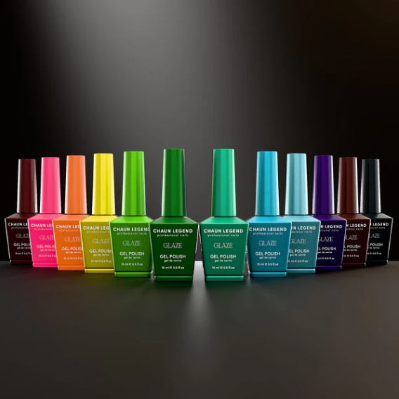Row of colorful nail polish bottles on a dark background