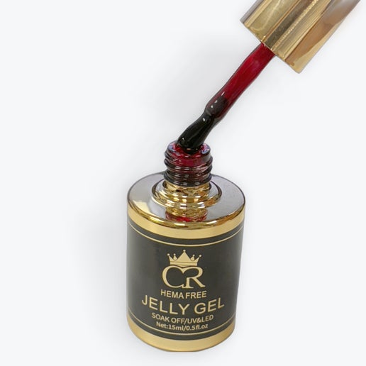 Nail gel polish bottle with red gel being applied, on a white background