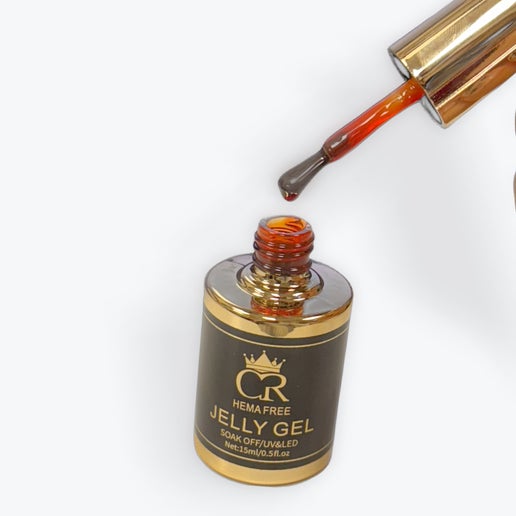 Jelly gel being poured from a bottle with a gold cap on a white background