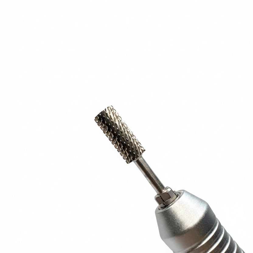 Close-up of a metallic rotary tool bit attachment with a textured, knurled cylindrical head, shown against a soft gray gradient background.
