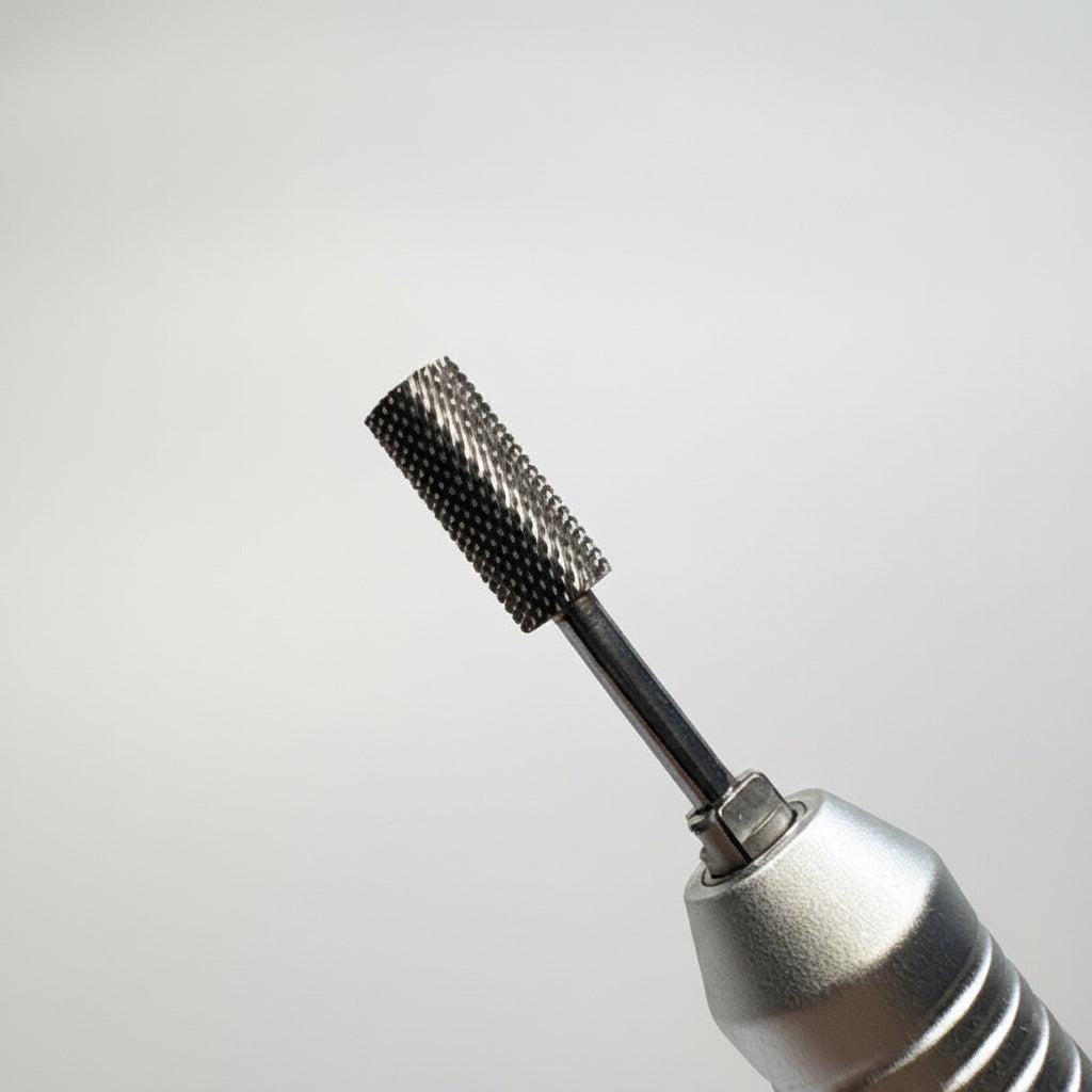 A close-up of a silver rotary tool bit with a textured, knurled metal cutting head, shown against a neutral gray gradient background.