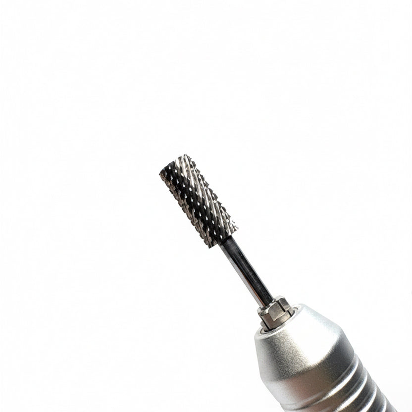 Close-up of a silver electric rotary tool bit with a textured, knurled metal cutting head on a neutral gray background.