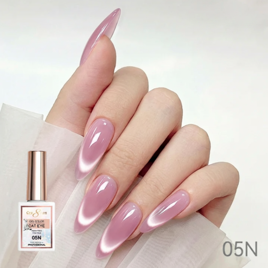 Hand with pink nail polish holding a bottle of nail polish, with 'Cre8tion' branding.