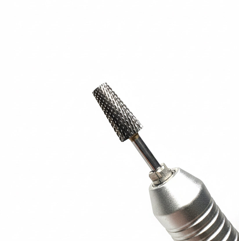 Close-up of a metallic handheld rotary tool bit with a textured, beaded cutting surface, shown against a soft gray gradient background.
