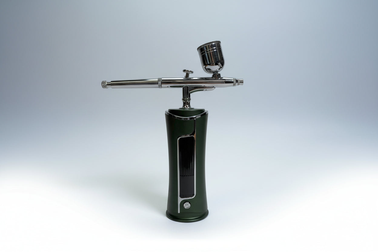 Green airbrush gun on a white background