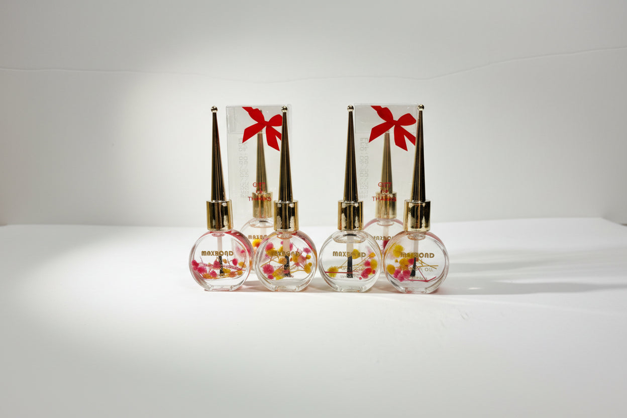 Set of five small perfume bottles with floral designs and gold caps on a white background.