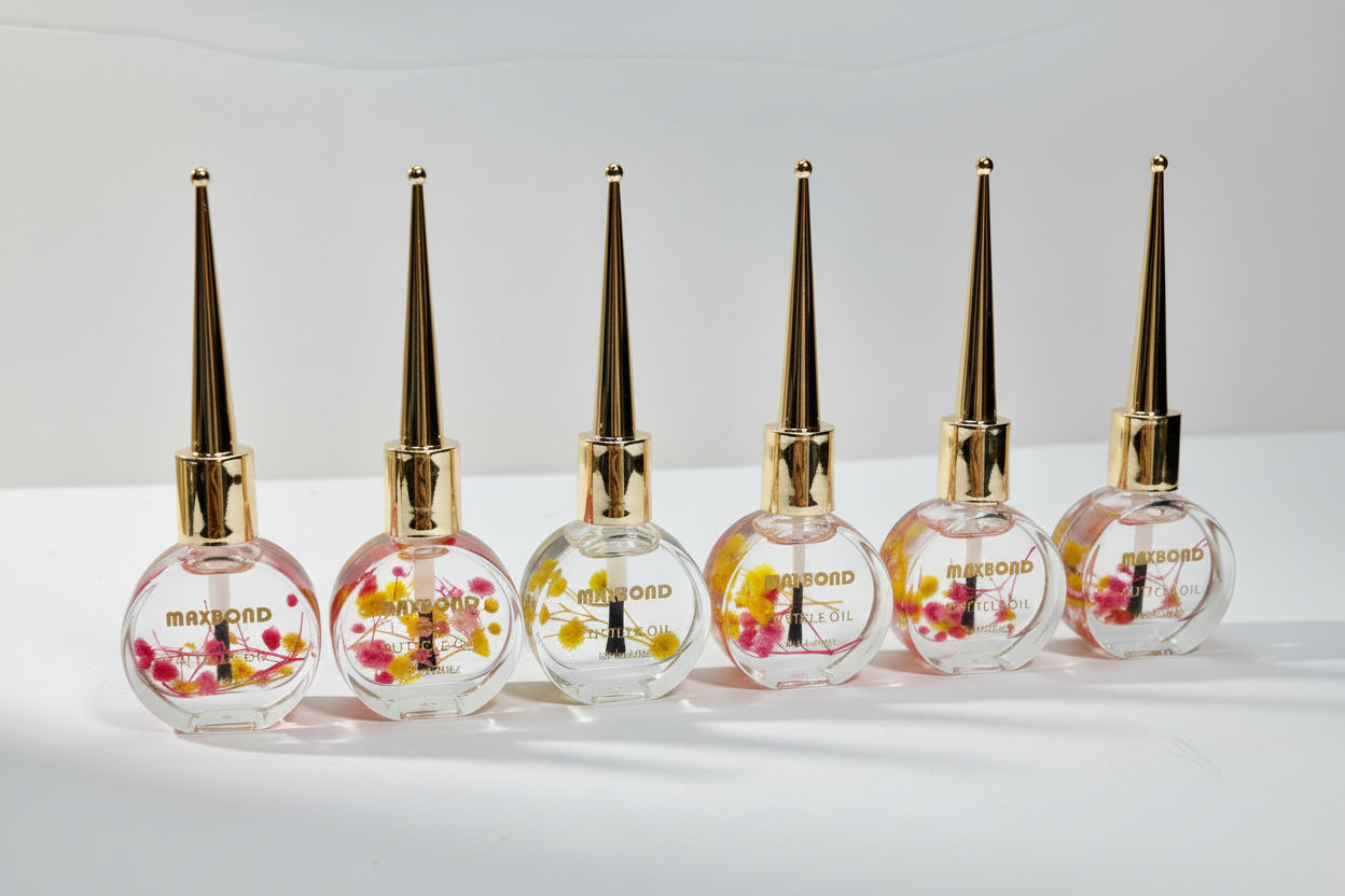 Set of six perfume bottles with floral designs on a white background