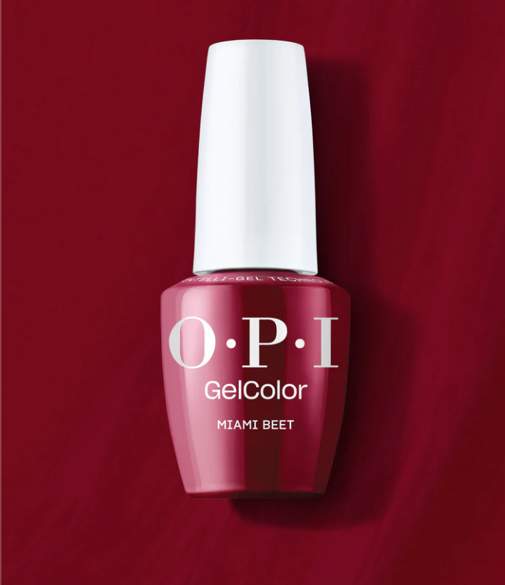 OPI GelColor nail polish bottle in Miami Beet on a red background