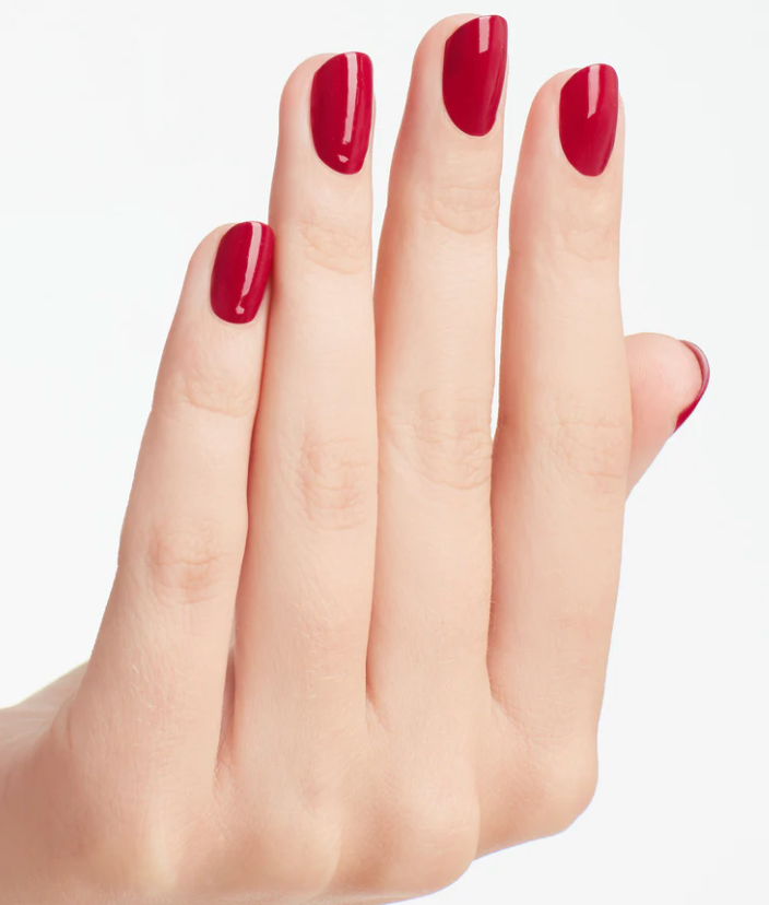 Hand with red nail polish on a white background