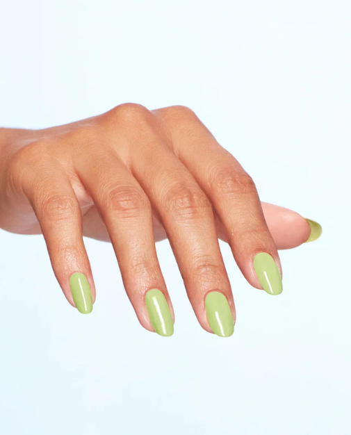 Hand with light green nail polish on a white background