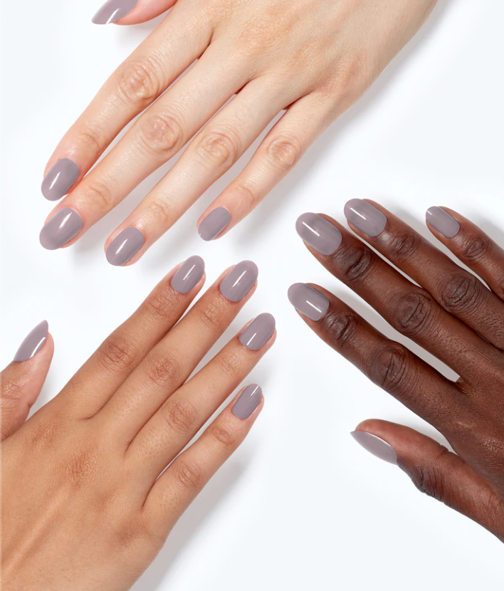 Three hands with light gray nail polish on a white background