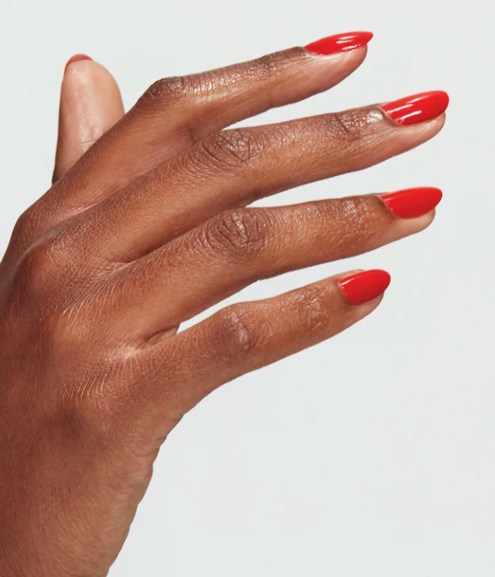 Hand with red nail polish on a white background