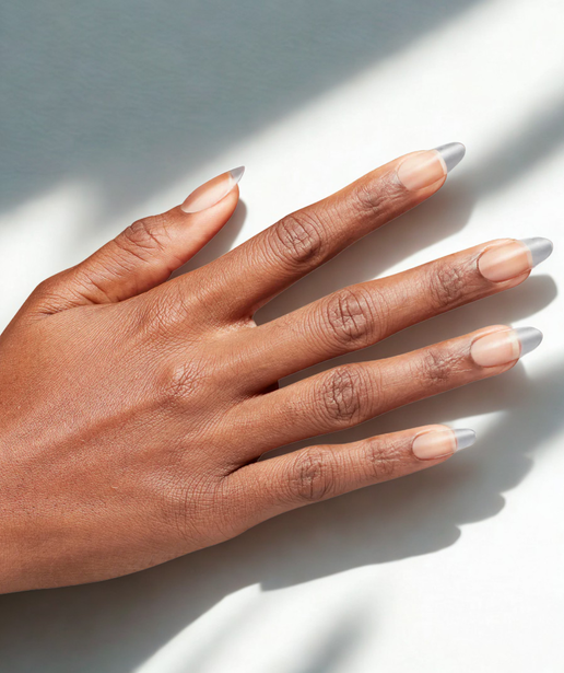 Hand with light nail polish on a white background