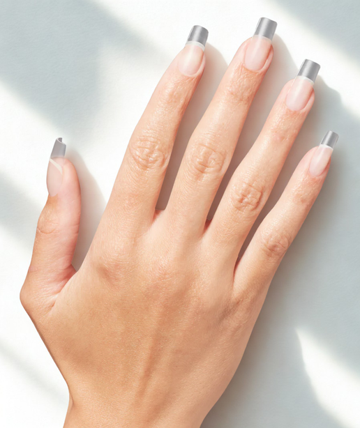 Hand with gray nail tips on a light background