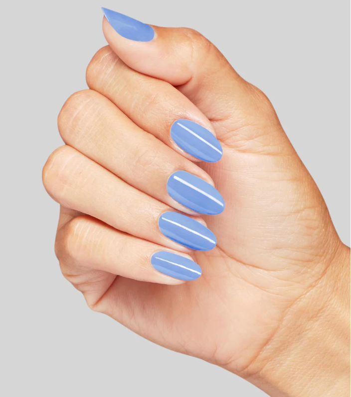 Hand with light blue nail polish on a plain background
