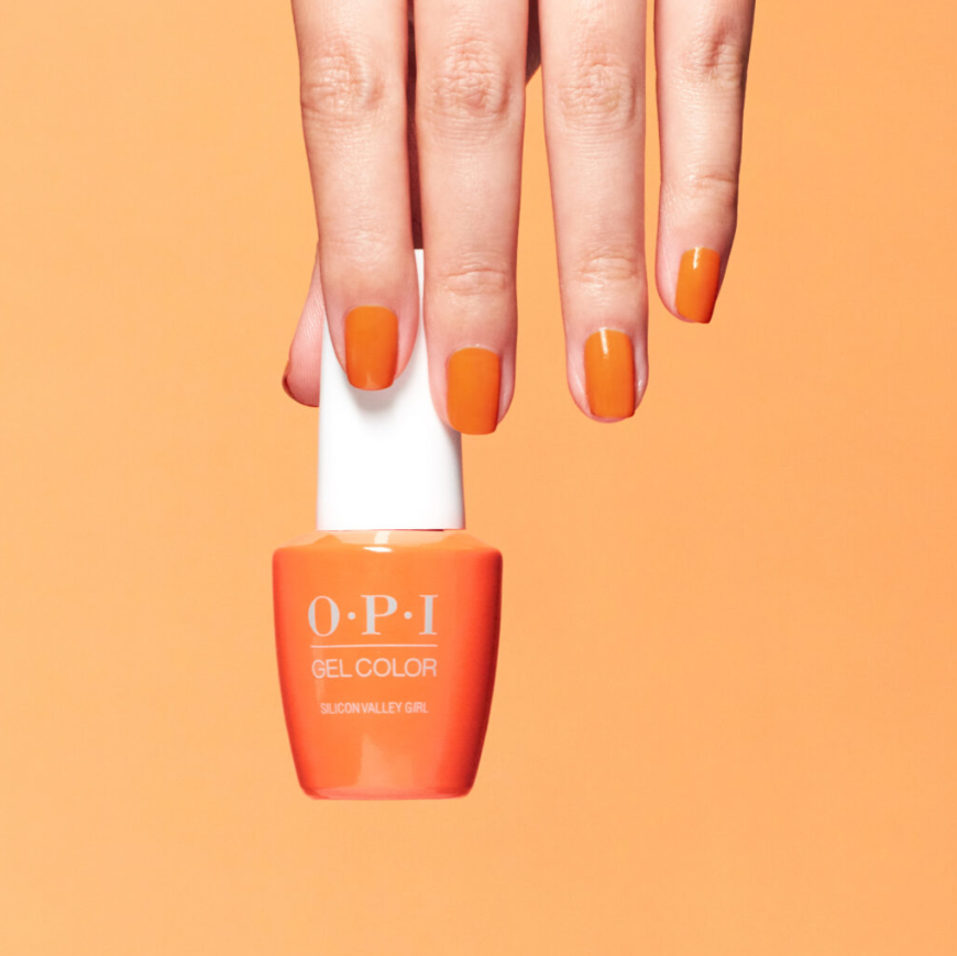 OPI nail polish bottle with orange nails on an orange background