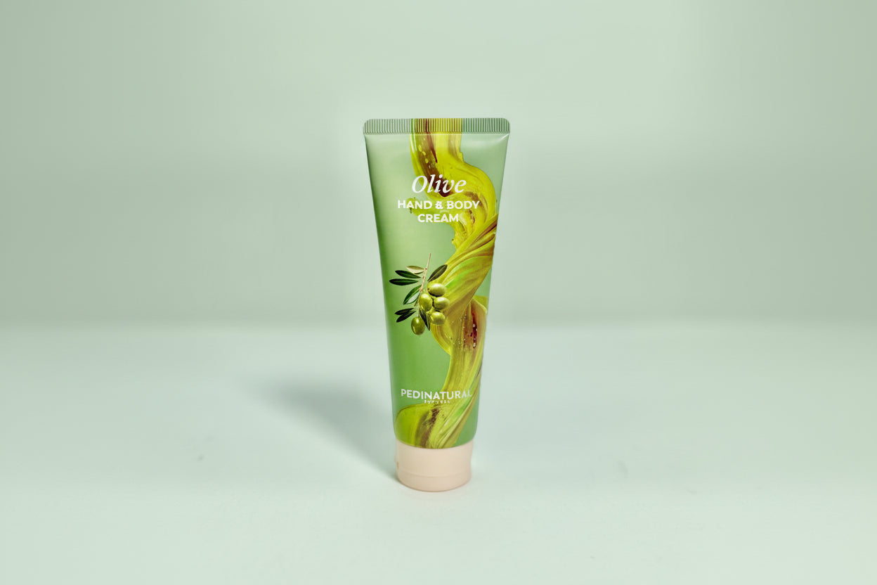 Tube of olive hand and body cream on a white background