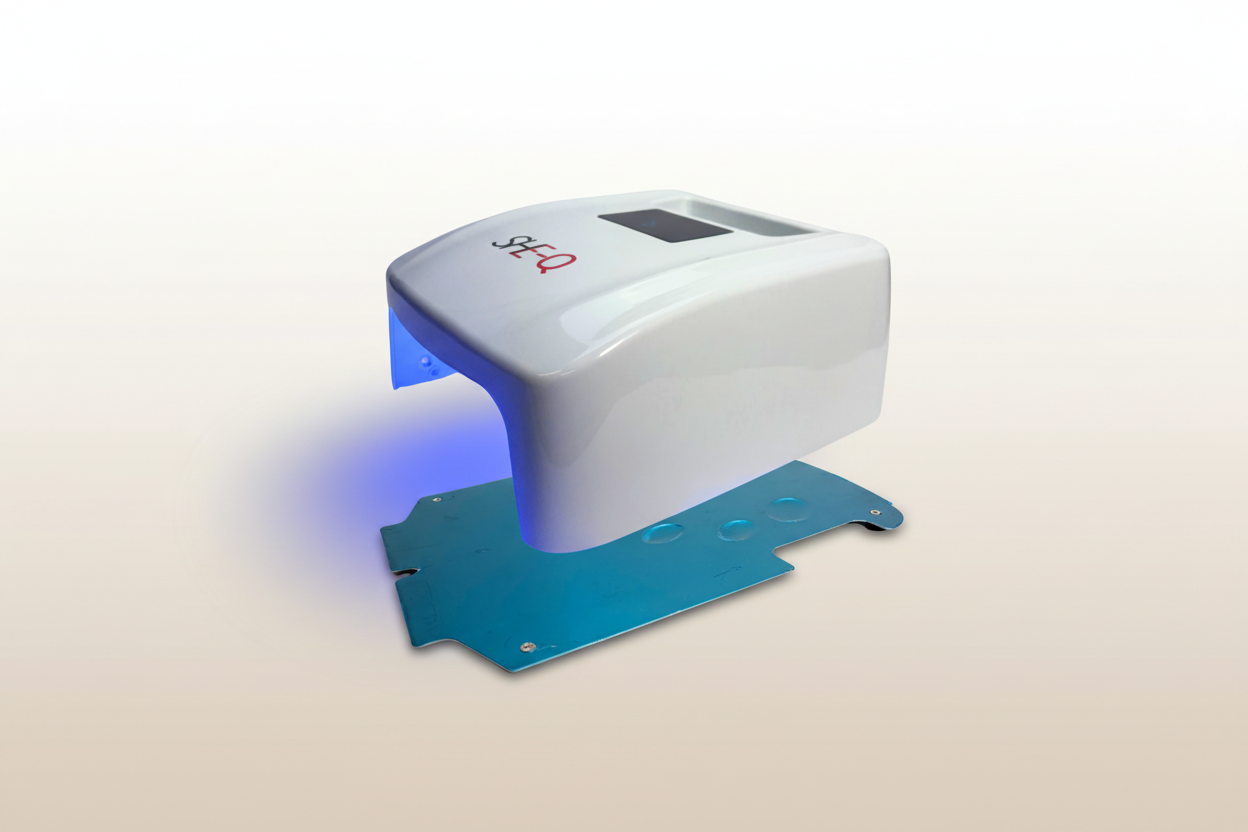 White electronic device with blue light on a white background