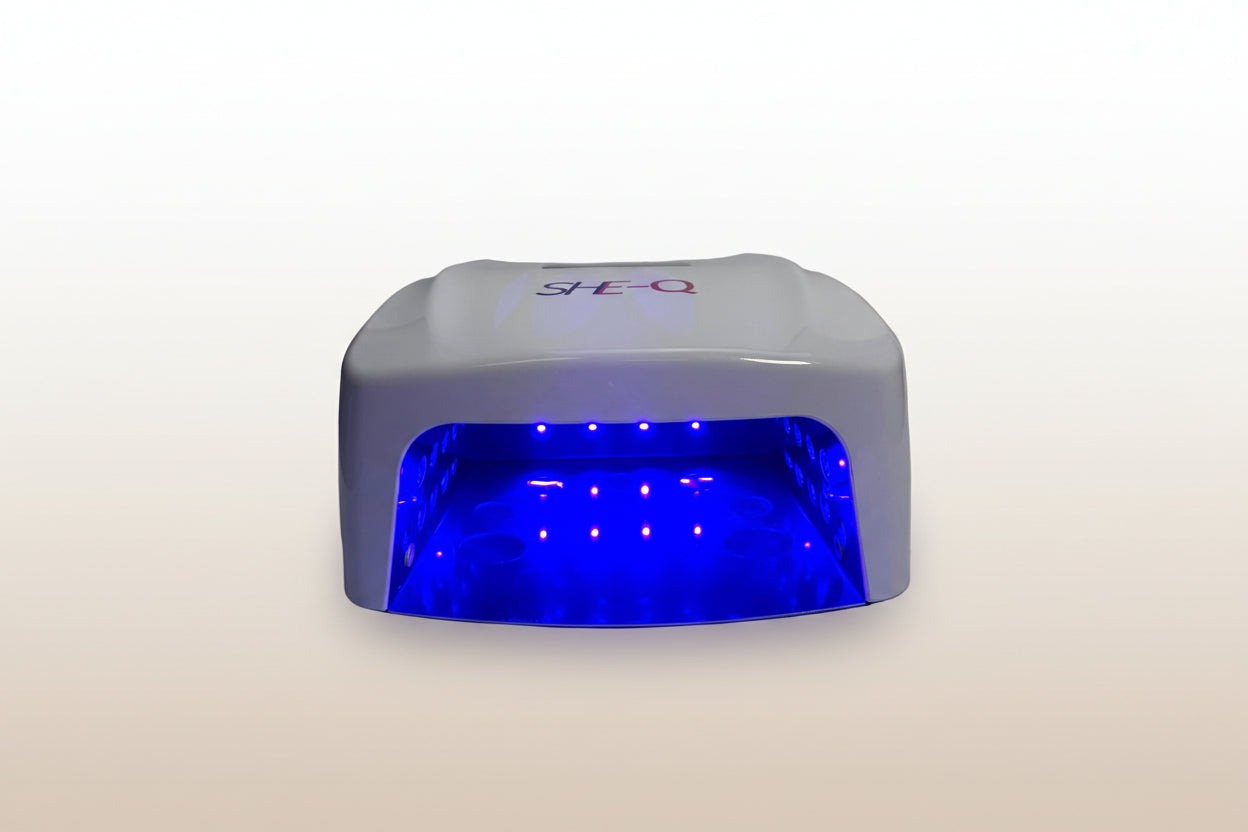 White nail dryer with blue light on a white background
