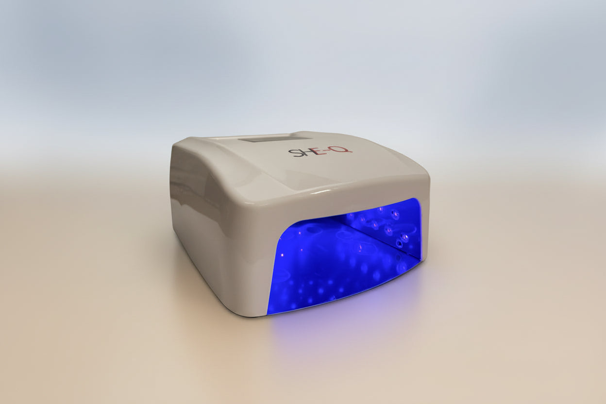 White nail dryer with blue light on a white background