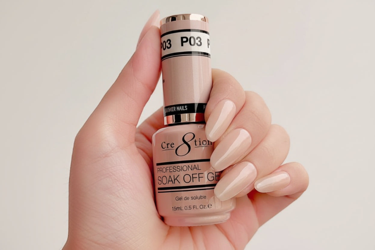 Hand holding a bottle of Cre8tion soak off gel with neatly manicured nails.