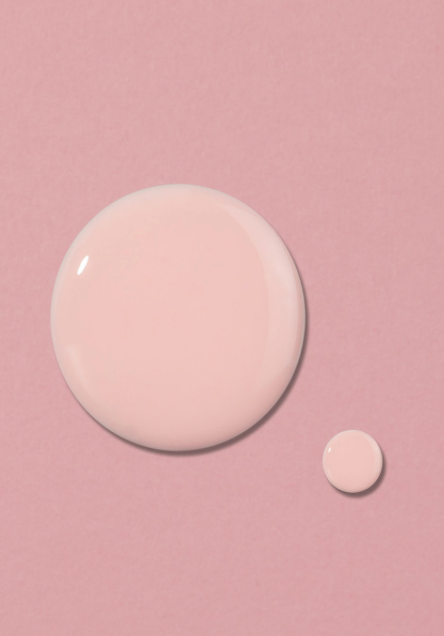 Two round, light pink objects on a soft pink background