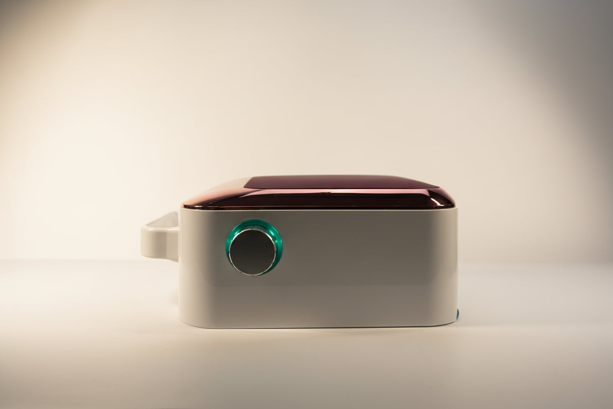 Modern wall-mounted electronic device with a green light on a white background