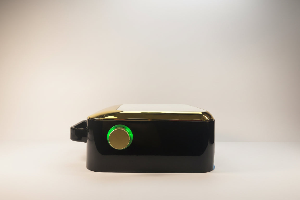 Black electronic device with a green light on a white background