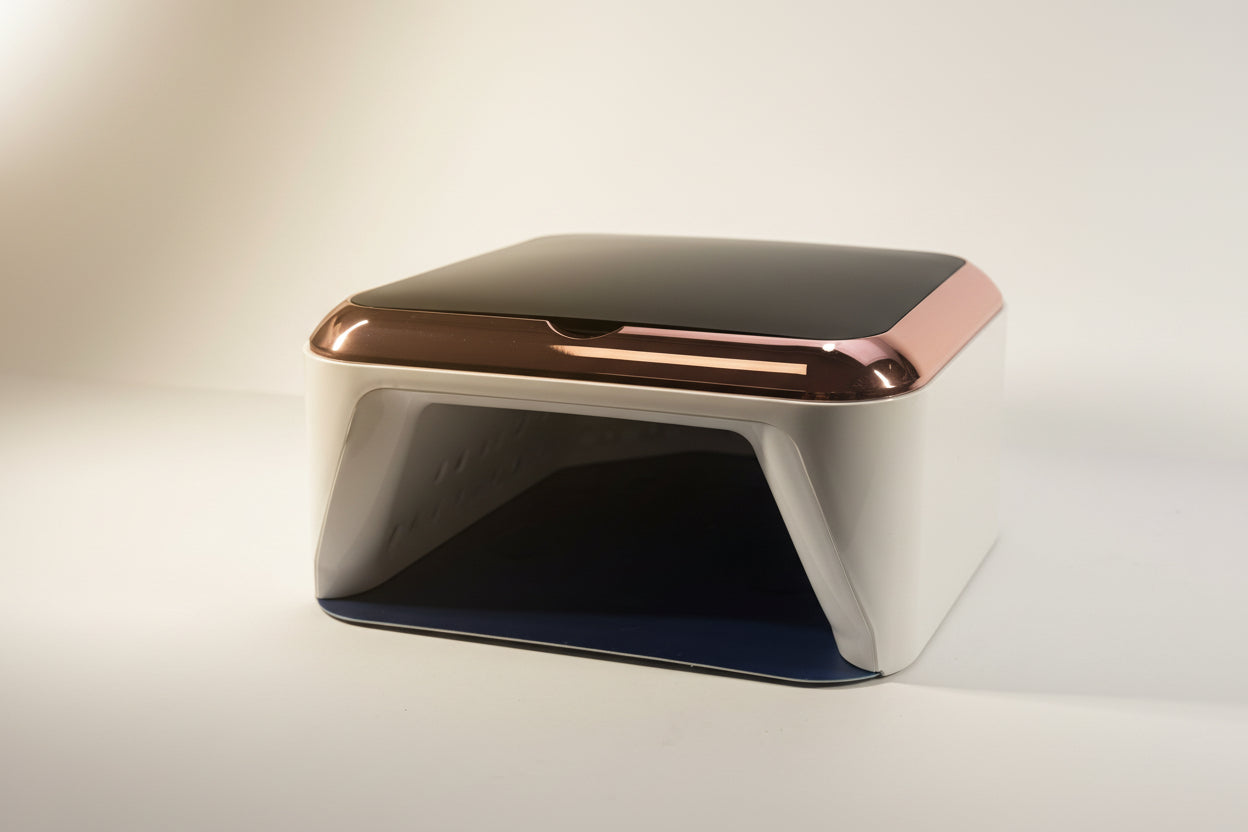 Modern metallic object with rose gold accents on a light background