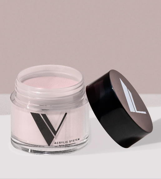 Jar of pink acrylic powder with a black lid on a light background