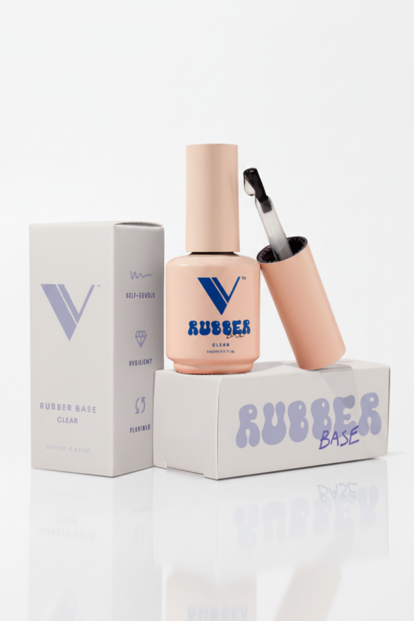 Nail polish bottle with applicator and packaging on a peach background