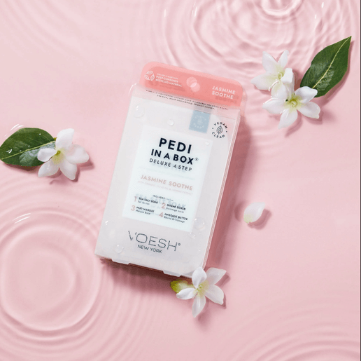 VOESH pedicure product on a pink background with flowers and leaves