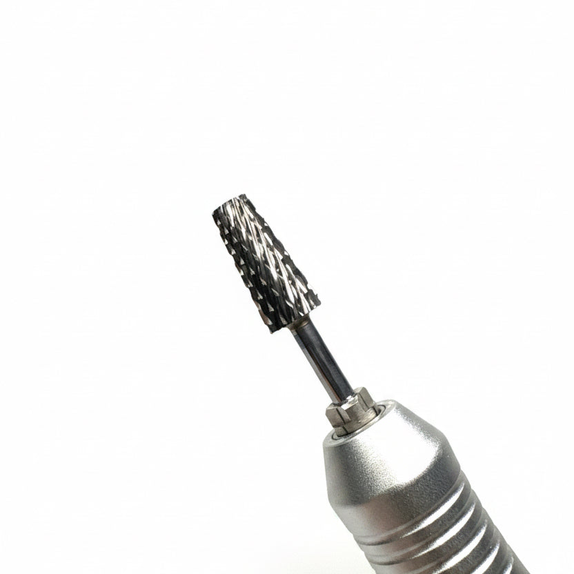 Close-up of a silver rotary pen device with a black and silver bristle brush attachment, shown against a soft gray gradient background.