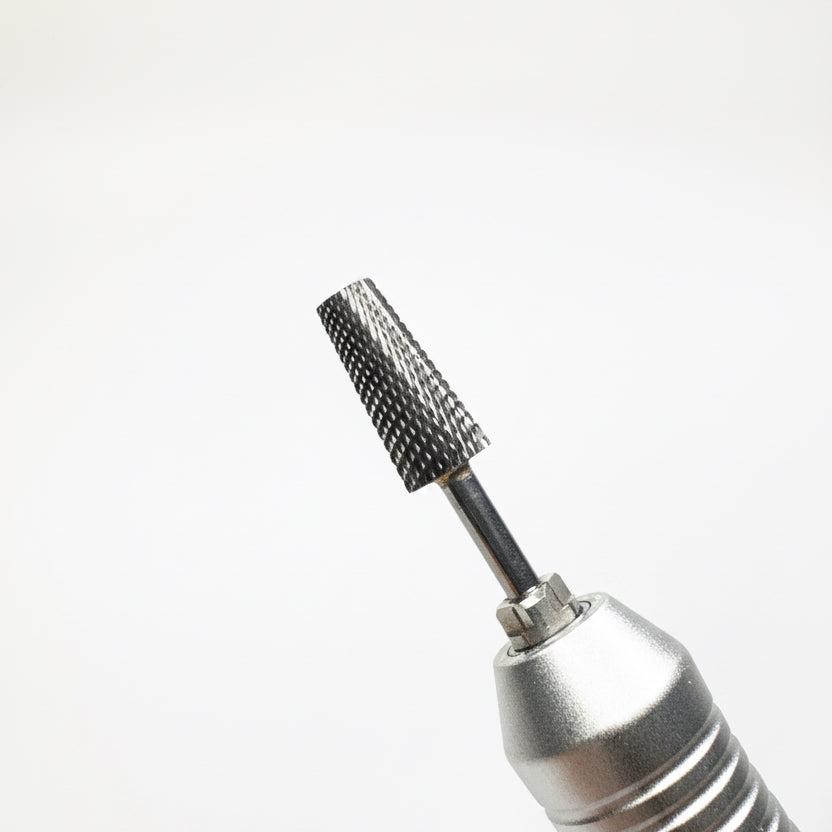Close-up of a metallic rotary tool bit with a textured, conical cutting or grinding tip, shown against a soft gray gradient background.