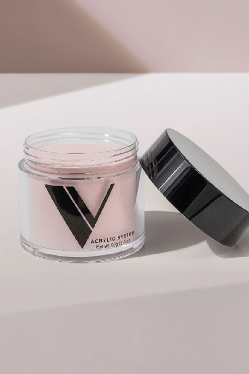 Jar of acrylic powder with a black lid on a light background